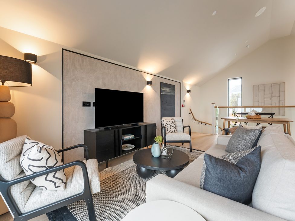 A living room with a sofa, chairs, and a television at tbc in St. Ives