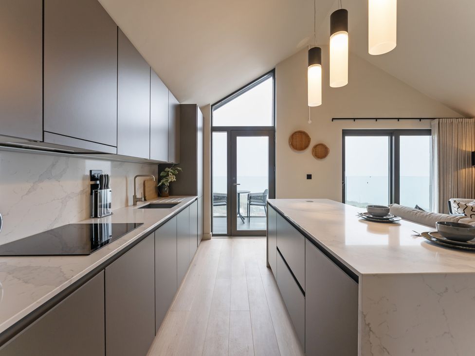 A kitchen with cabinets and an island at tbc in St. Ives