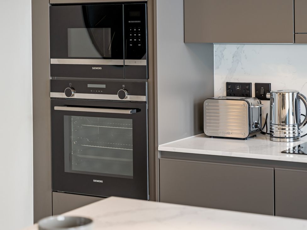 A kitchen with built-in oven and microwave at tbc in St. Ives