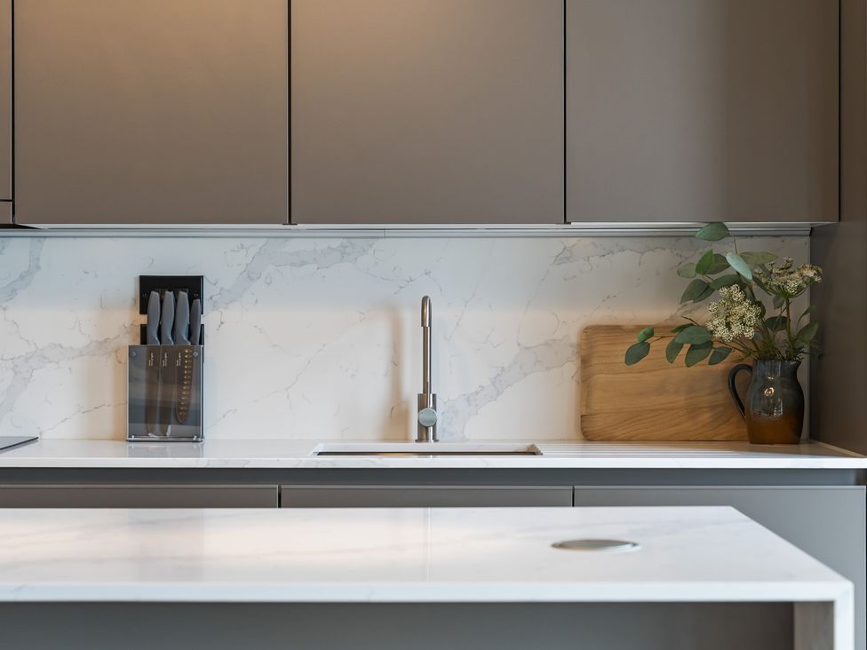 A kitchen with a sink and knife block at tbc St. Ives