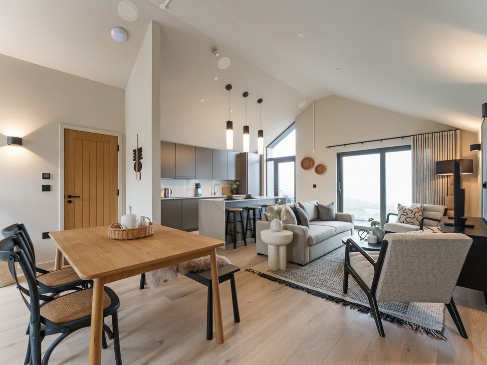 A living room and kitchen area with furniture at tbc in St. Ives