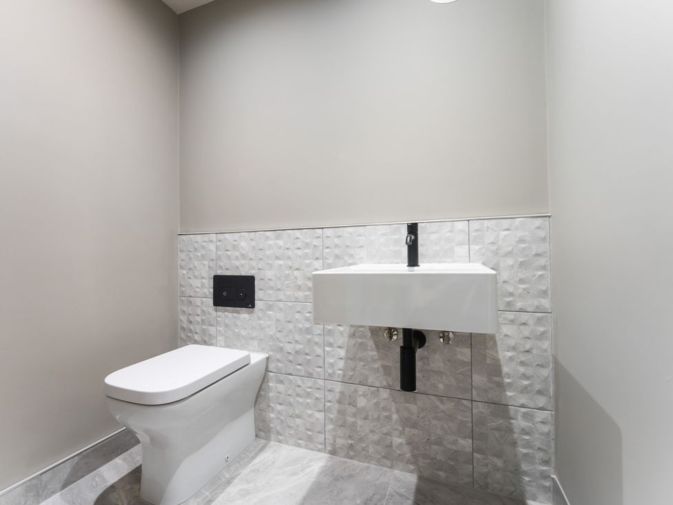 A bathroom with a toilet and sink at tbc in St. Ives
