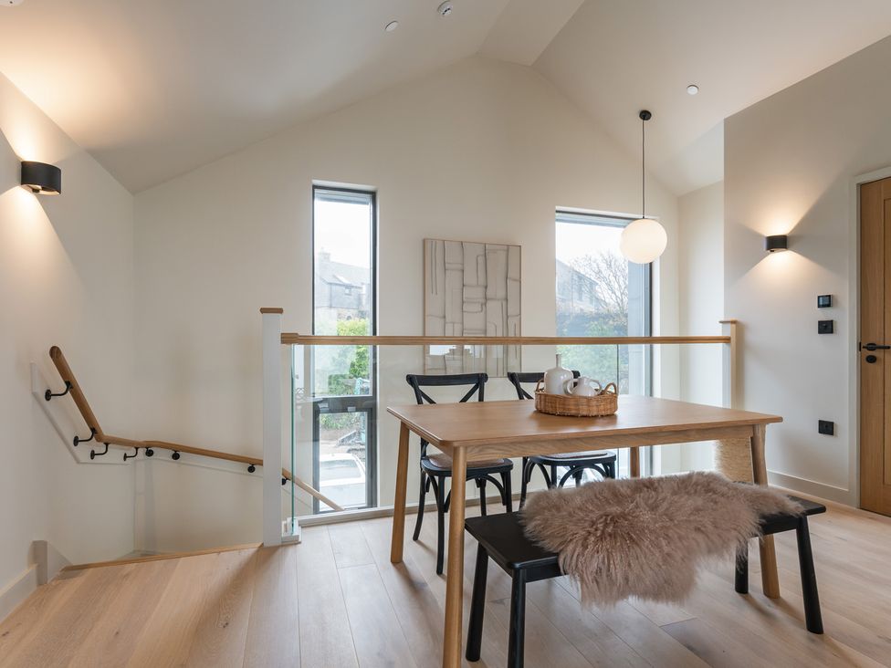 A dining room with a table and chairs at tbc in St. Ives