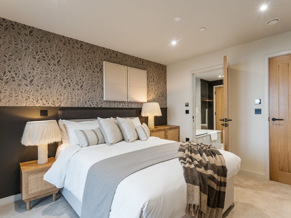 A bedroom with a bed and bedside table at The Old Barn in St. Ives