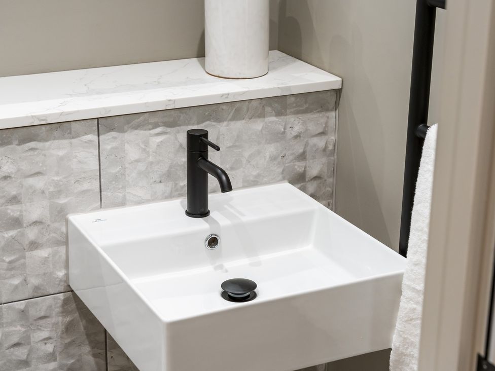 A sink with a black faucet in a bathroom at tbc in St. Ives