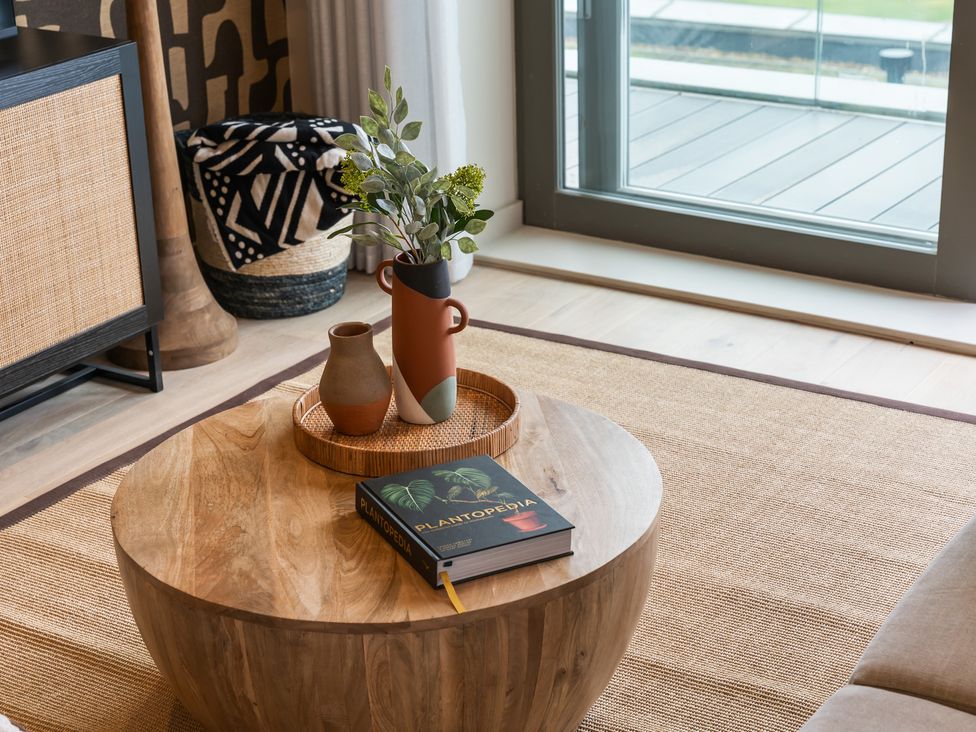 A living room with a coffee table and plants at tbc in St. Ives