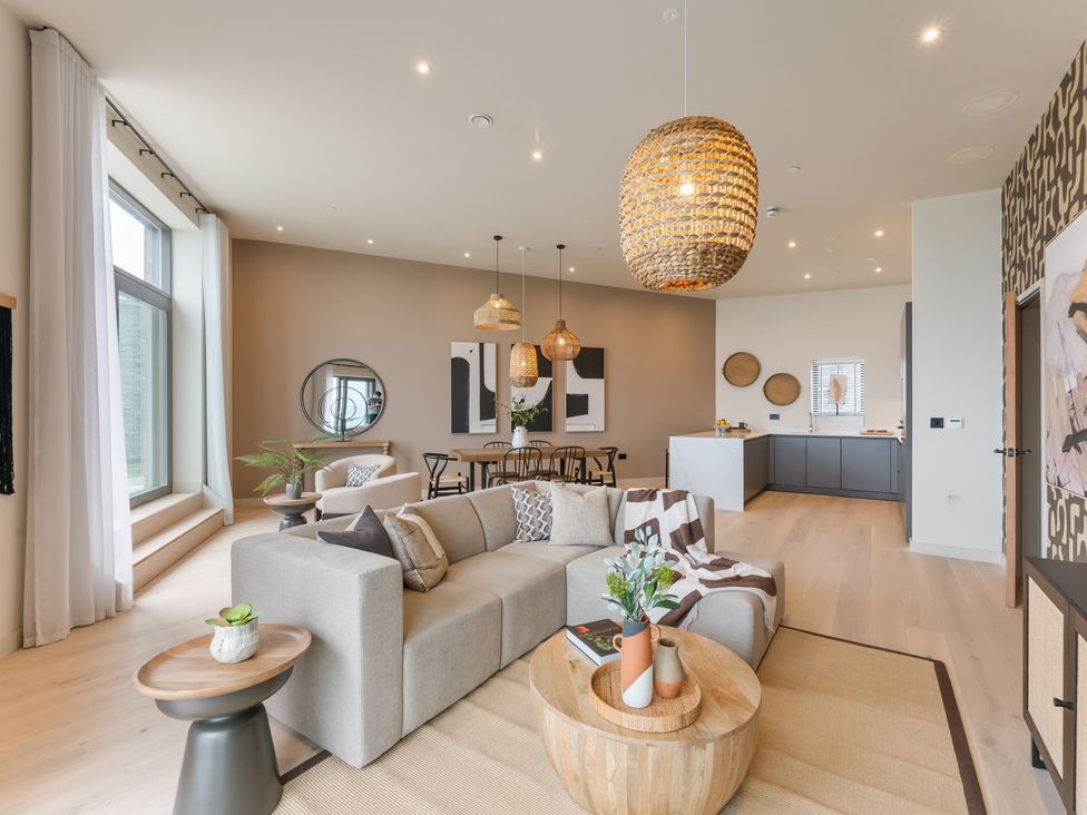 A living room with a sofa and dining area at tbc in St. Ives