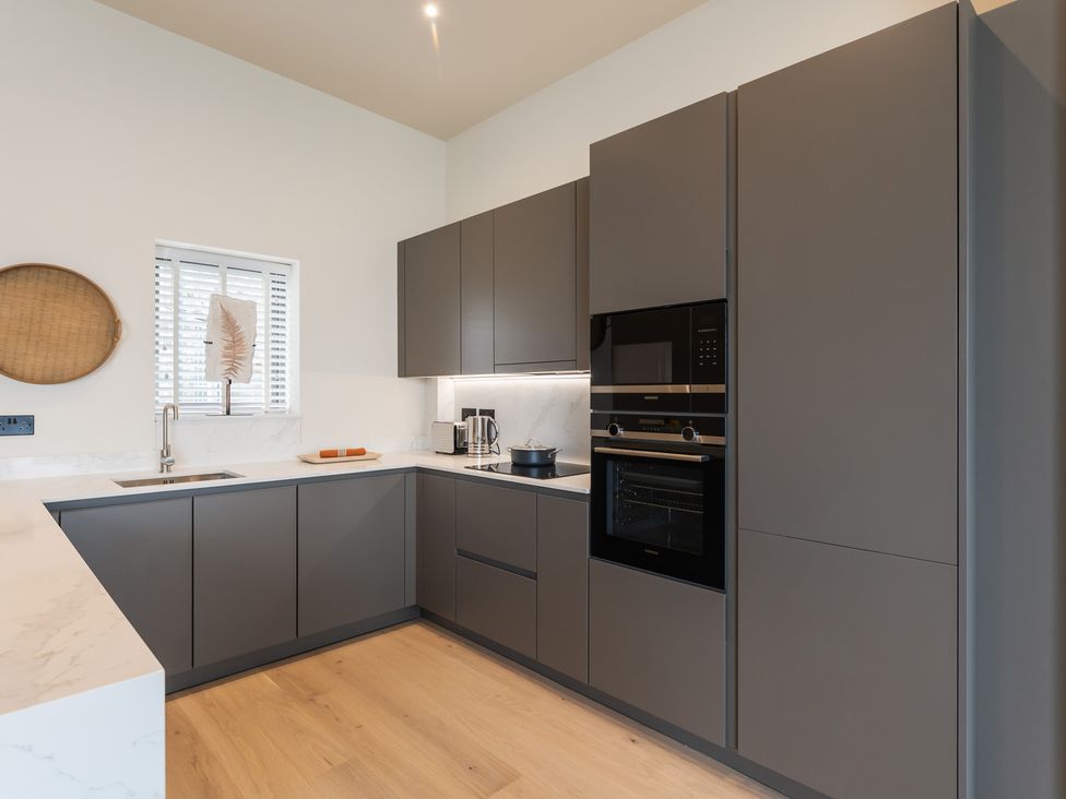 A kitchen with cabinets and appliances at tbc St. Ives