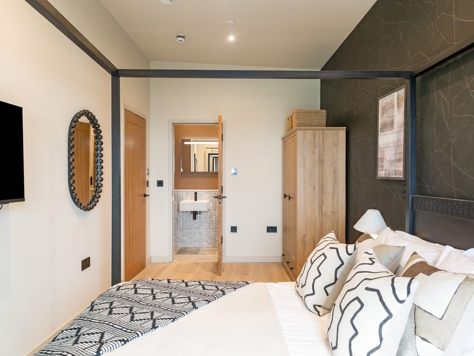 A bedroom with a bed and attached bathroom at tbc St. Ives