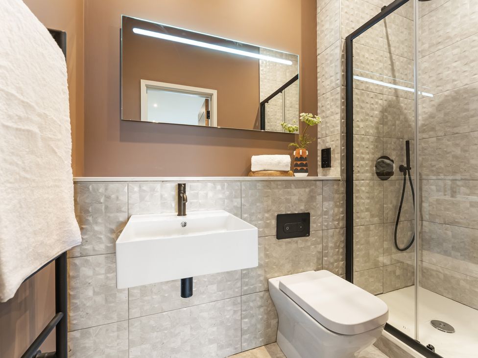 A bathroom with a sink, toilet, and shower at tbc St. Ives