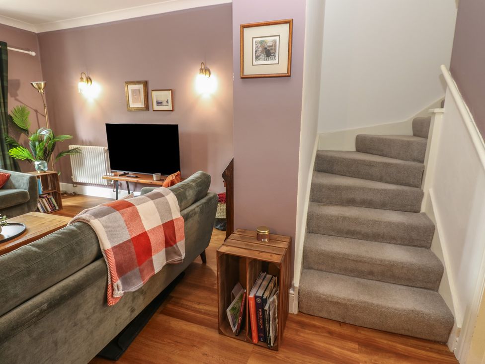 A living room with a sofa and television at 2 West View in Richmond