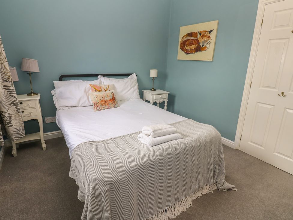 A bedroom with a bed and bedside table at 2 West View in Richmond