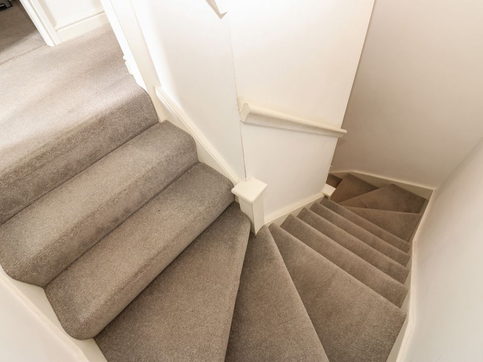 A staircase with carpet and a handrail at 2 West View Richmond