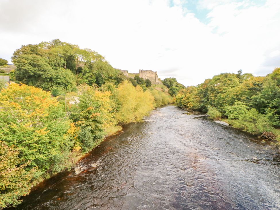 A river with trees and a castle in the background at 2 West View Richmond