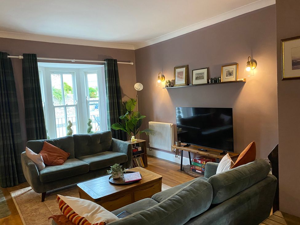 A living room with a sofa and television at 2 West View in Richmond