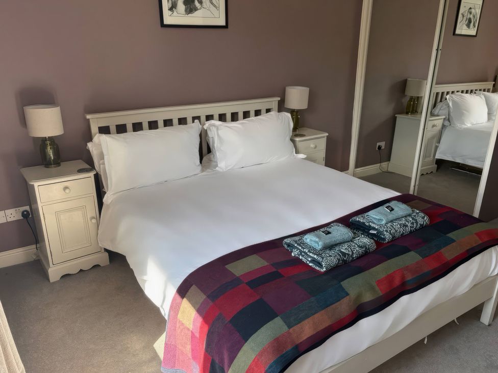 A bedroom with a bed and nightstand at 2 West View, Richmond