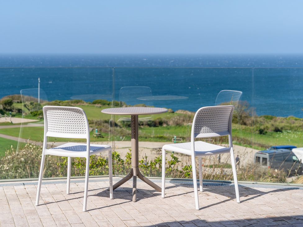 A table and chairs on an outdoor terrace overlooking the sea at tbc in St. Ives