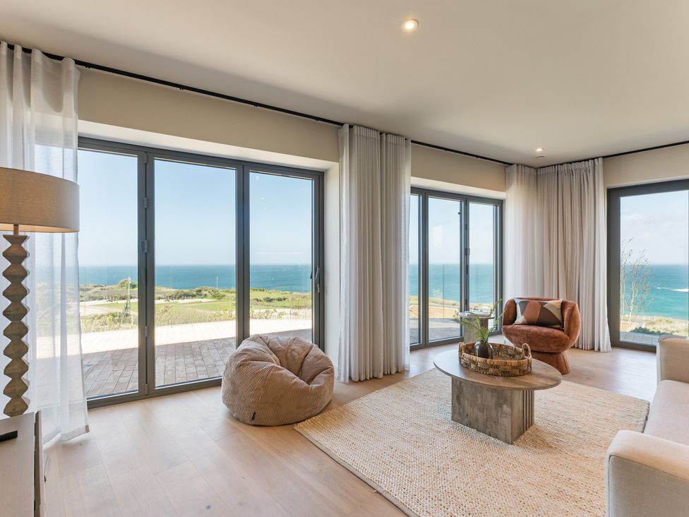 A living room with a coffee table and views of the sea at tbc in St. Ives