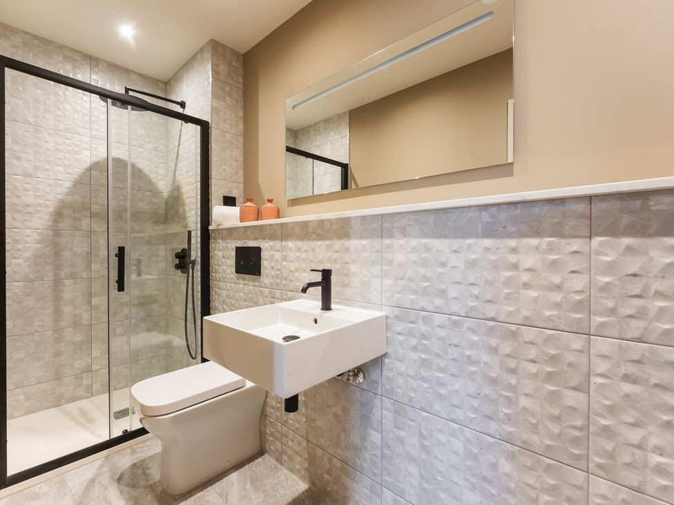 A bathroom with a shower, sink and toilet at tbc in St. Ives