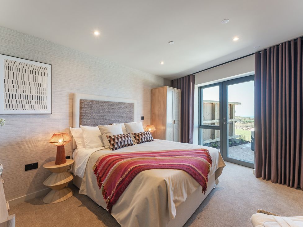 A bedroom with a bed and wardrobe at tbc in St. Ives