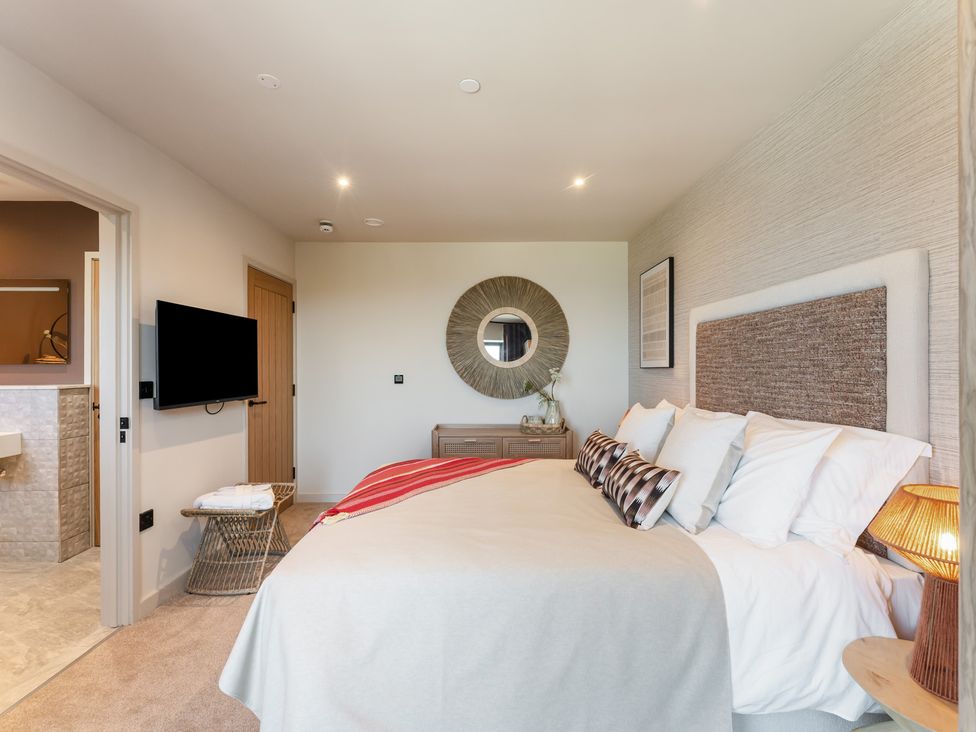 A bedroom with a bed and television at tbc St. Ives