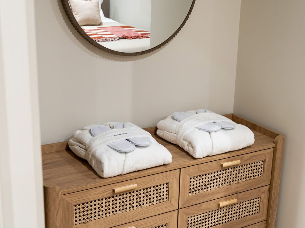 A storage unit with robes on top in a bedroom at tbc in St. Ives