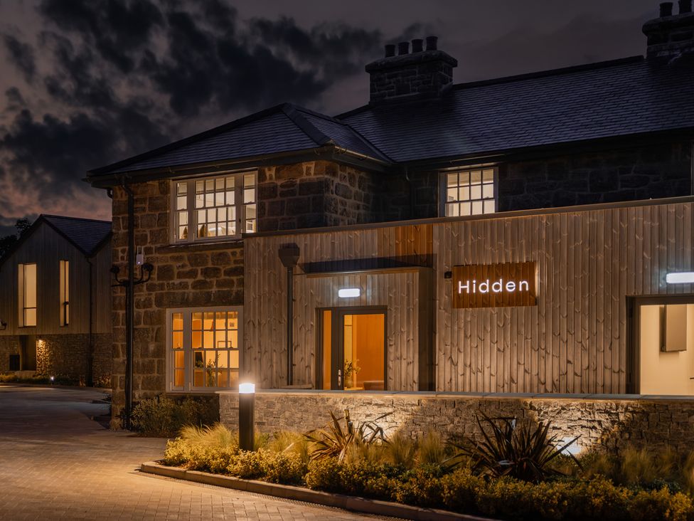 A building entrance with a sign at Hidden 18- St Ives Bay Suite Hot Tub in St Ives