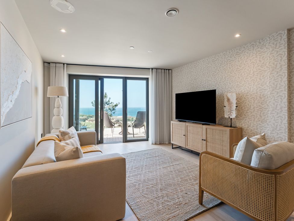 A living room with a sofa and television at tbc in St. Ives