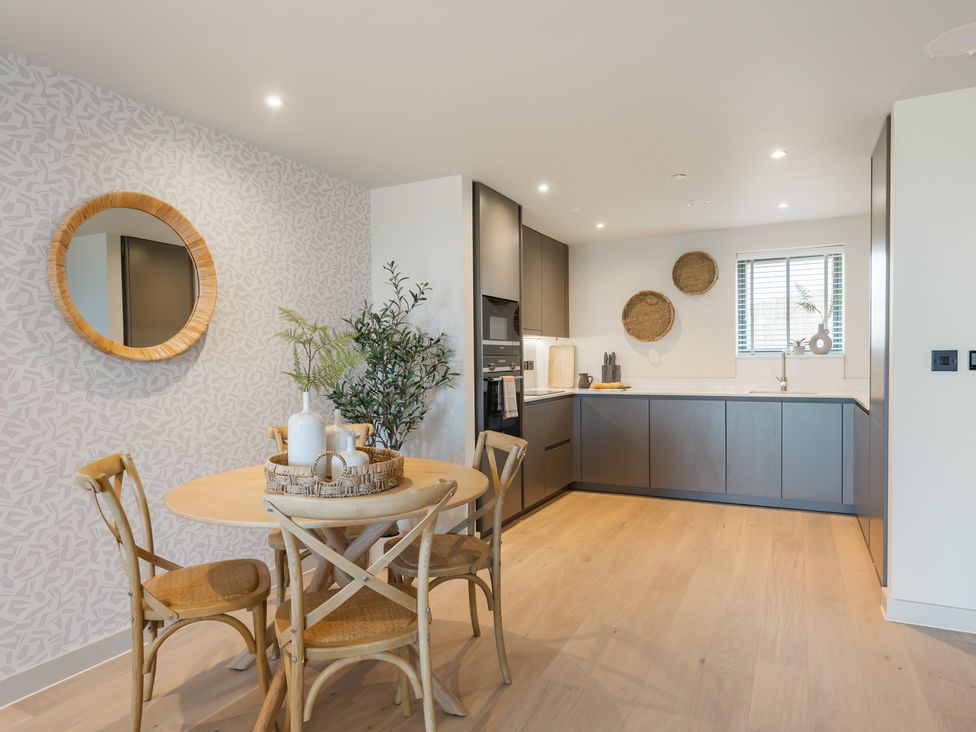 A kitchen with dining table and appliances at tbc St. Ives