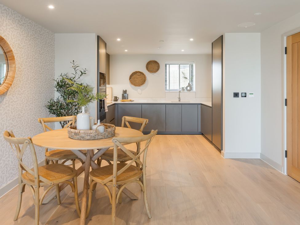 A dining room with a table and chairs at The Old Barn in St. Ives