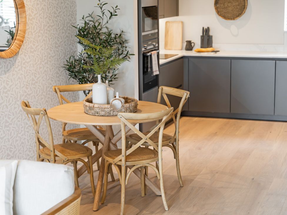 A dining area with a round table and chairs at tbc in St. Ives