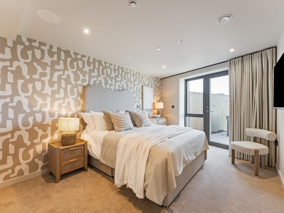 A bedroom with a bed and bedside table at tbc in St. Ives