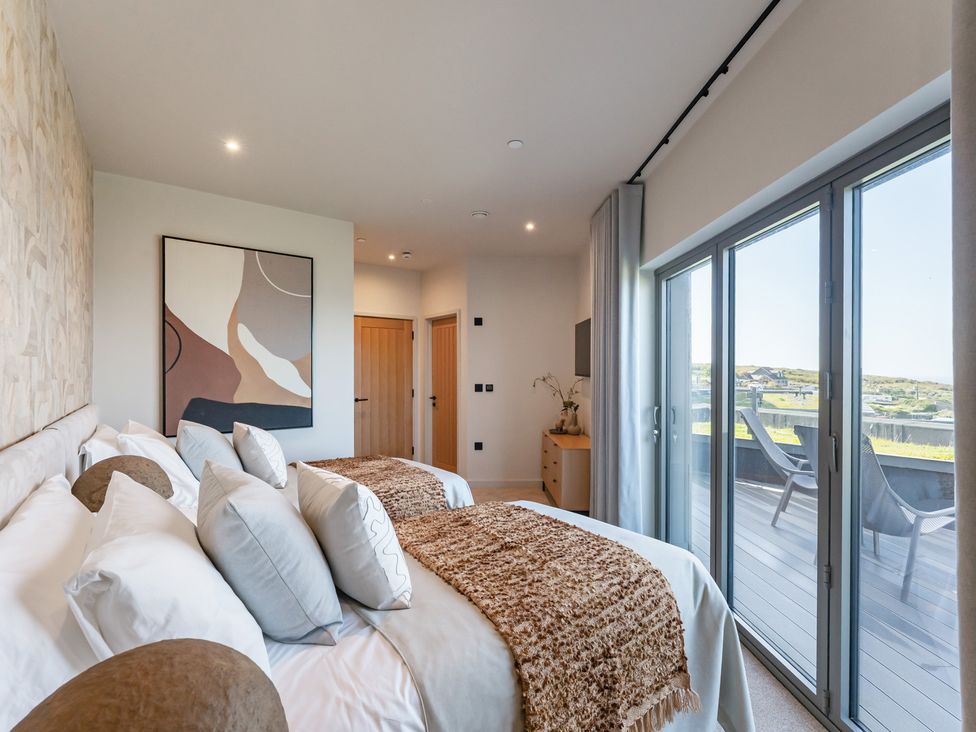 A bedroom with two beds and a view at tbc in St. Ives