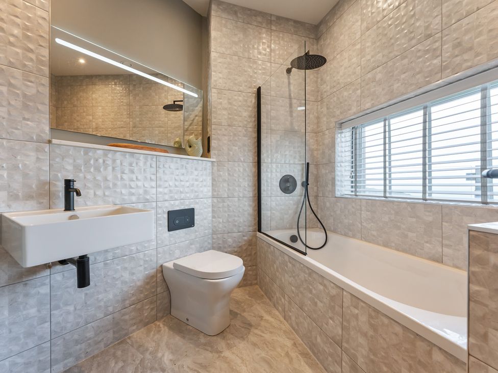 A bathroom with a bathtub and shower at tbc in St. Ives