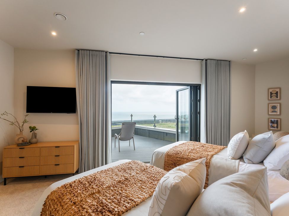 A bedroom with two beds and a television at tbc in St. Ives