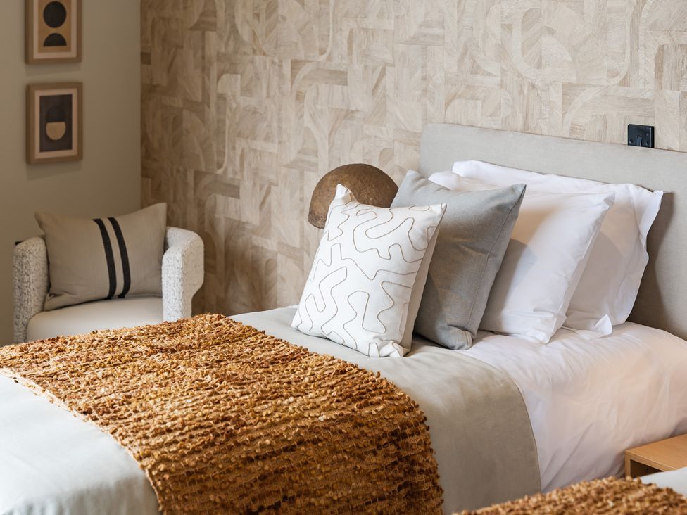 A bedroom with a bed and a chair at tbc St. Ives