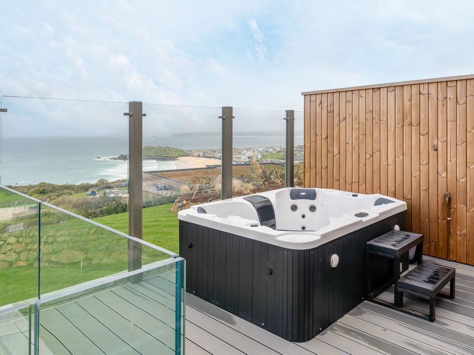 An outdoor area featuring a hot tub with a view at tbc St. Ives