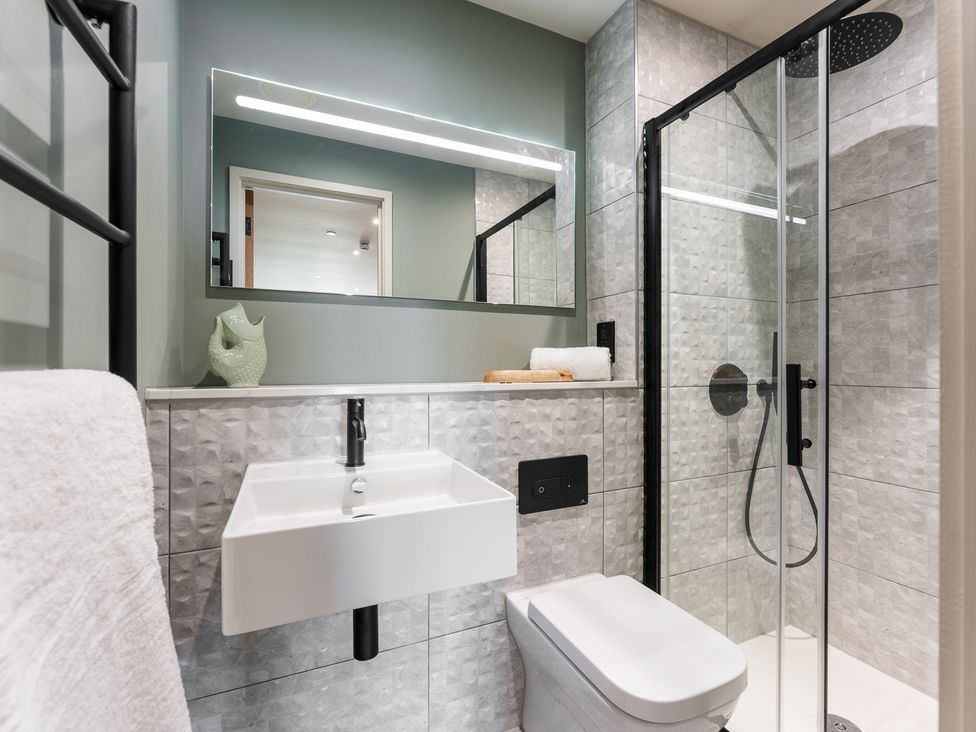 A bathroom with a shower, sink, and toilet at tbc in St. Ives