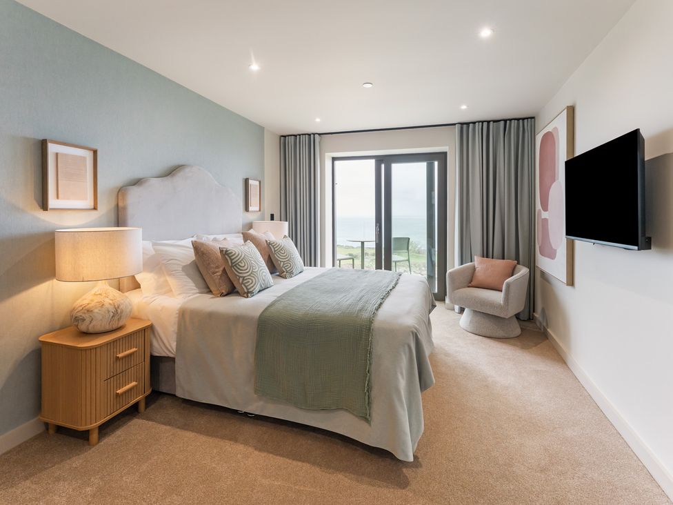A bedroom with a bed and a nightstand at tbc in St. Ives