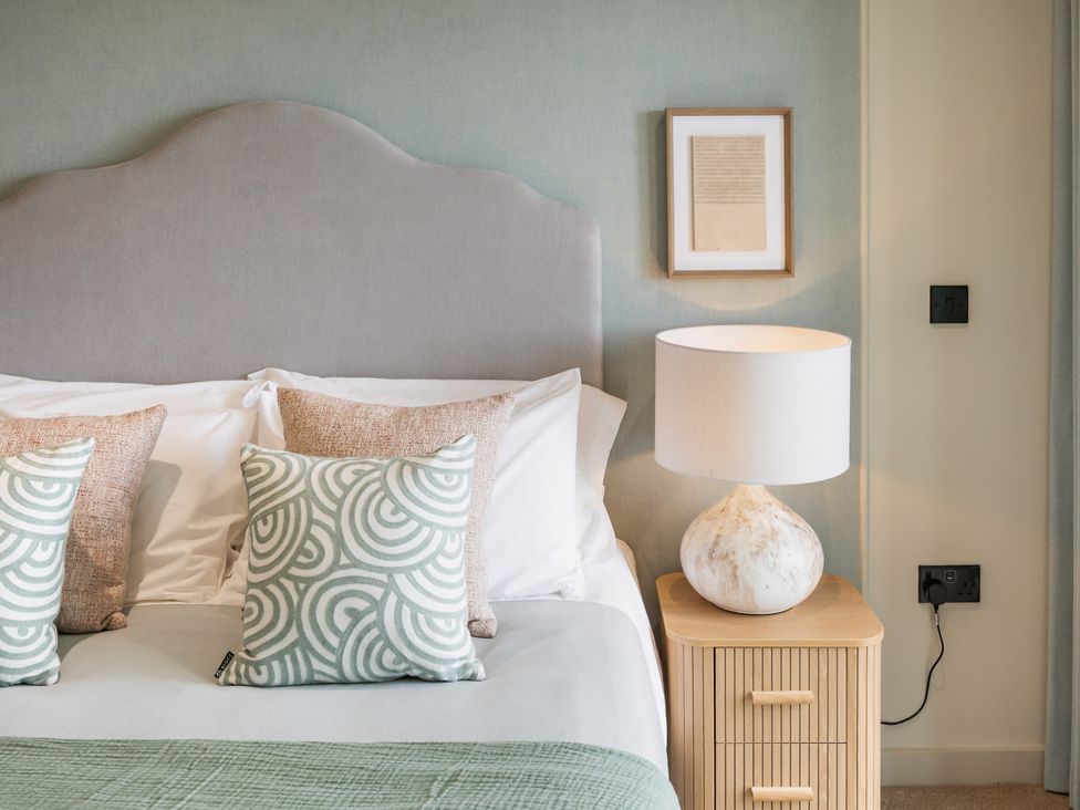 A bedroom with bed and bedside table at tbc in St. Ives