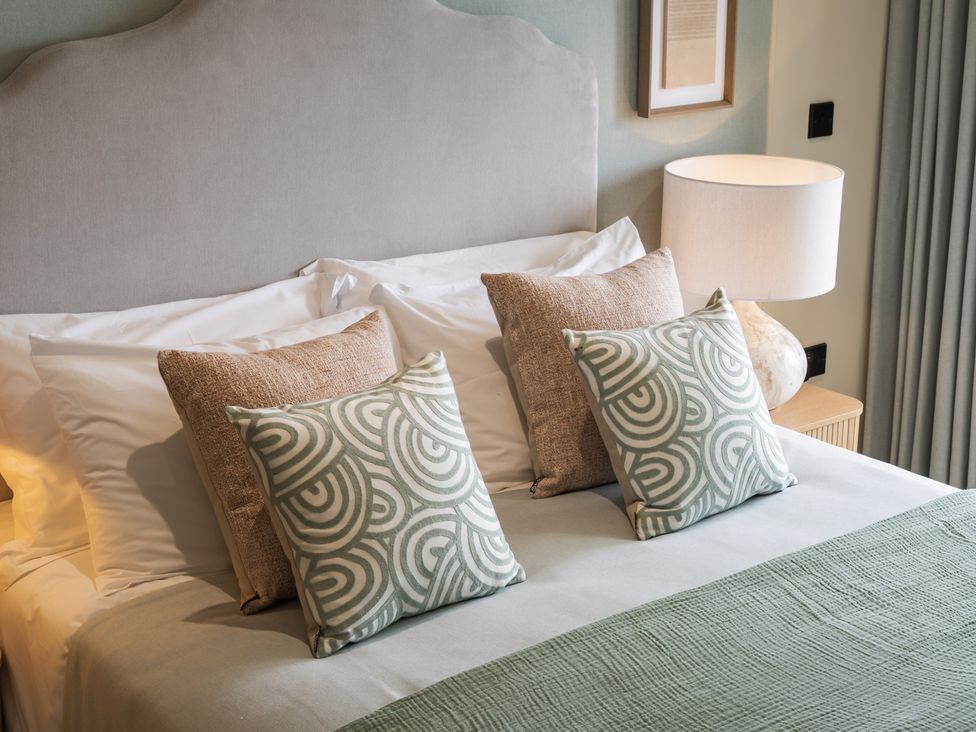 A bedroom with a bed and pillows at tbc St. Ives
