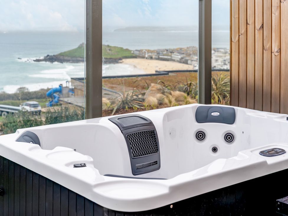 A hot tub with a sea view at tbc in St. Ives