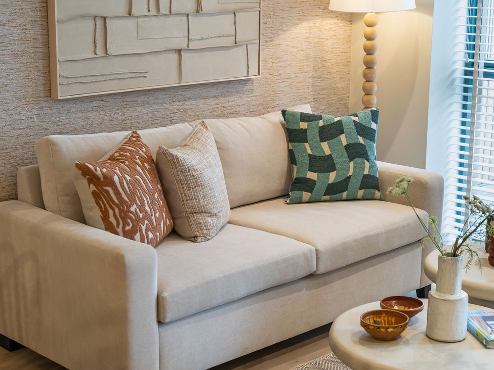 A living room with a sofa and decor at Hidden 19- Coastal Hot Tub in St Ives