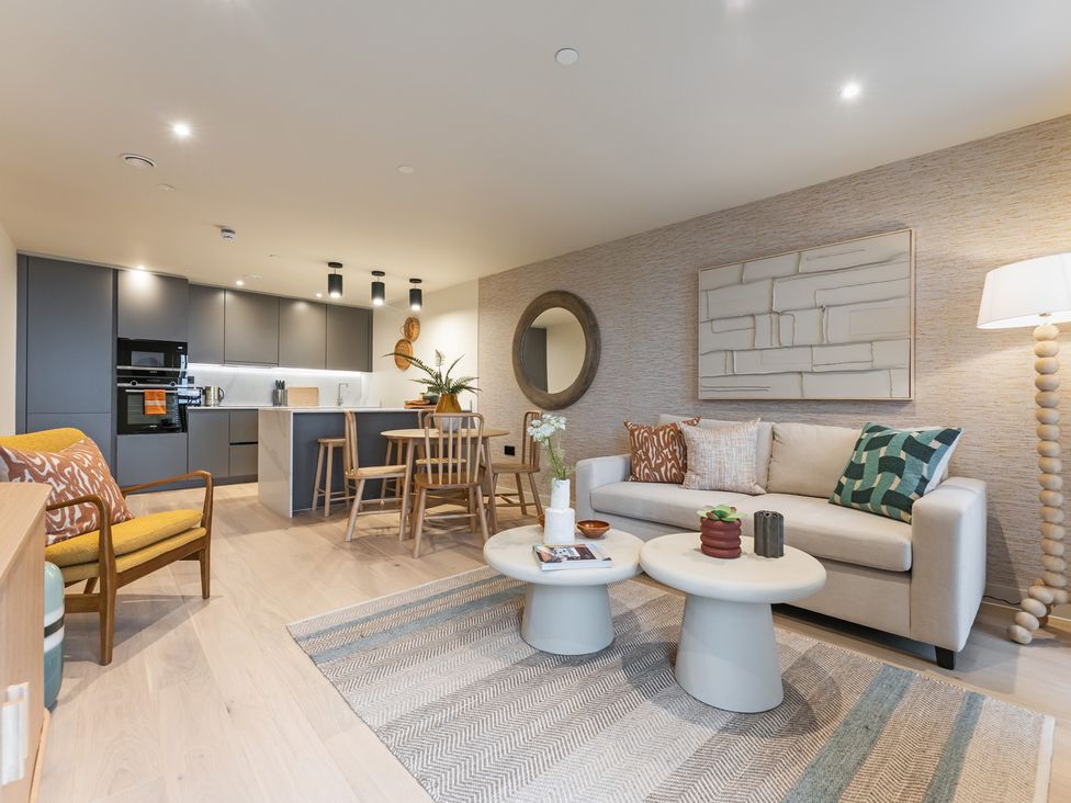 A living room with furniture and kitchen area at Hidden 19- Coastal Hot Tub St Ives