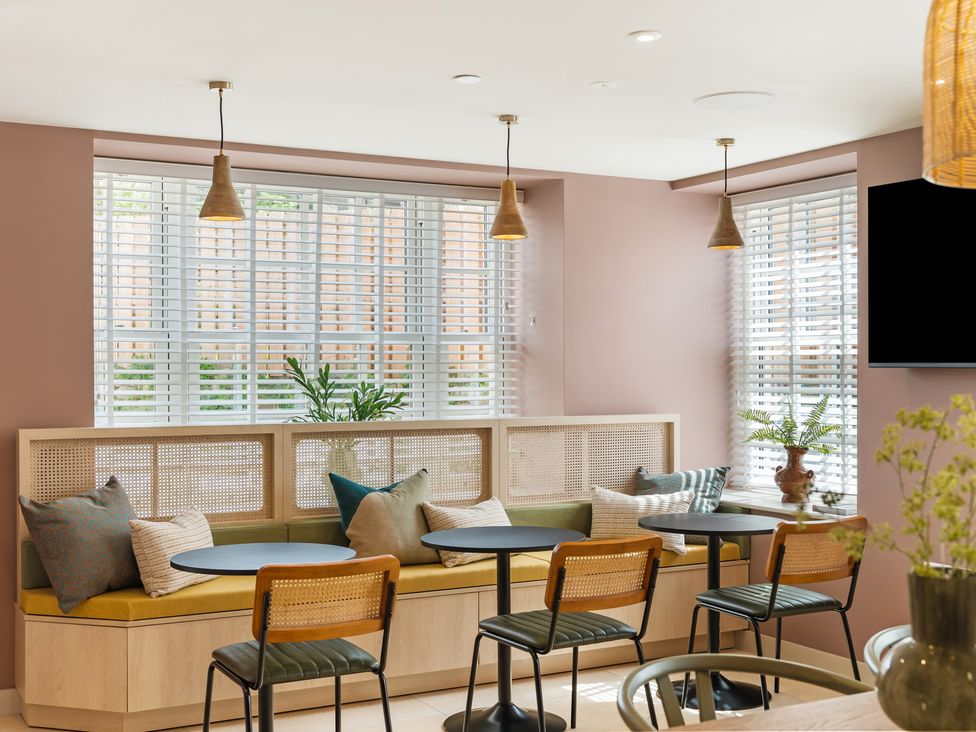 A dining room with seating and plants at Hidden 20- Gallery Hot Tub in St Ives