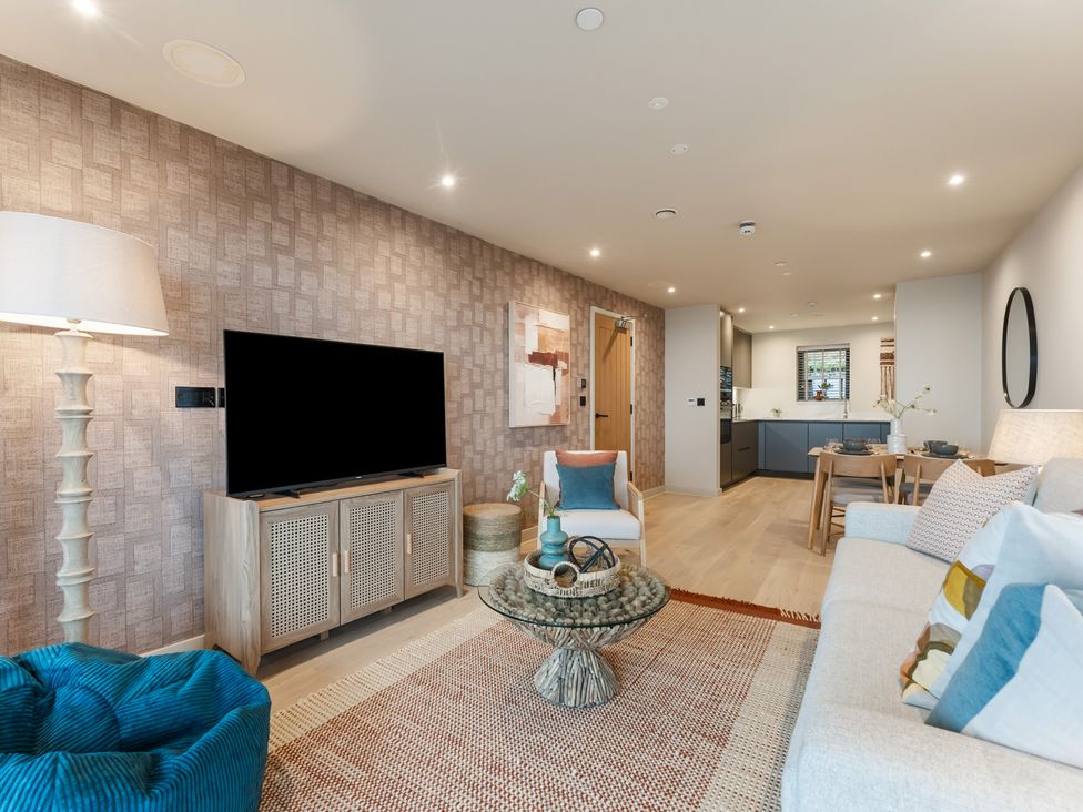 A living room with a sofa and television at tbc in St. Ives