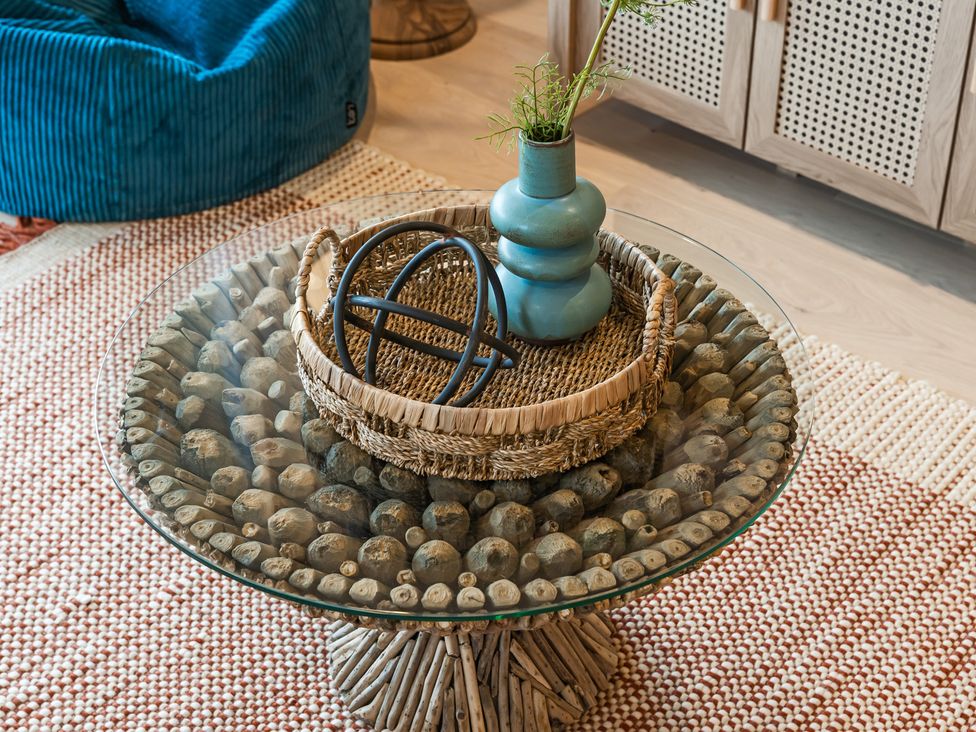 A living room with a table and decorative items at tbc in St. Ives
