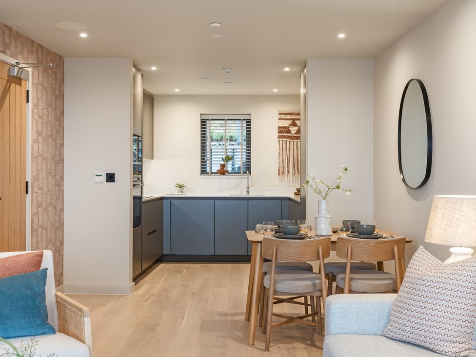 A kitchen with dining area and wall art at tbc in St. Ives