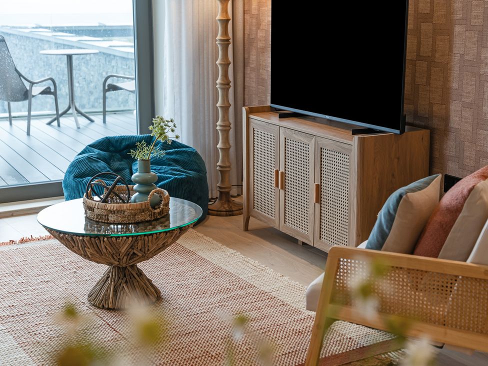 A living room with a coffee table and television at tbc St. Ives