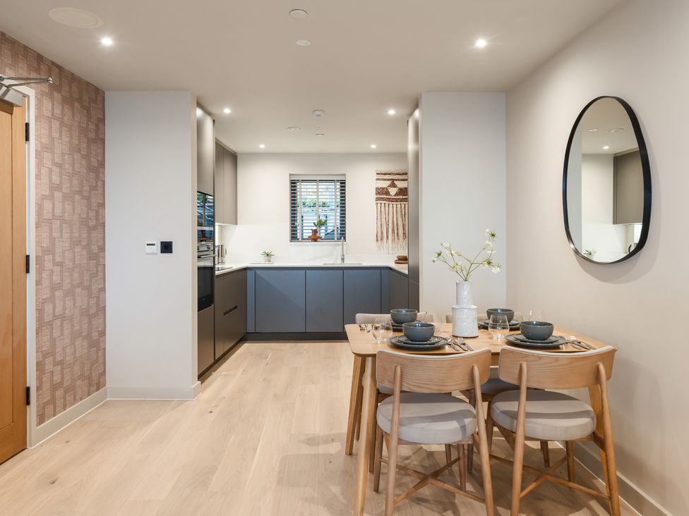 A dining area with a table and chairs in a kitchen at tbc in St. Ives